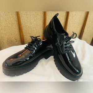 Unisex platform shoes. Black lacquer. Never worn. Women size 8.5, Men size 7.